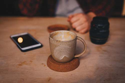 mobile phone brown cup on brown saucer phone